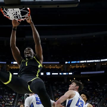 Mar 23, 2024; Pittsburgh, PA, USA; Oregon Ducks center N'Faly Dante (1) dunks the ball against Creighton Bluejays guard Baylor Scheierman (55) in the second round of the 2024 NCAA Tournament at PPG Paints Arena. Mandatory Credit: Charles LeClaire-USA TODAY Sports