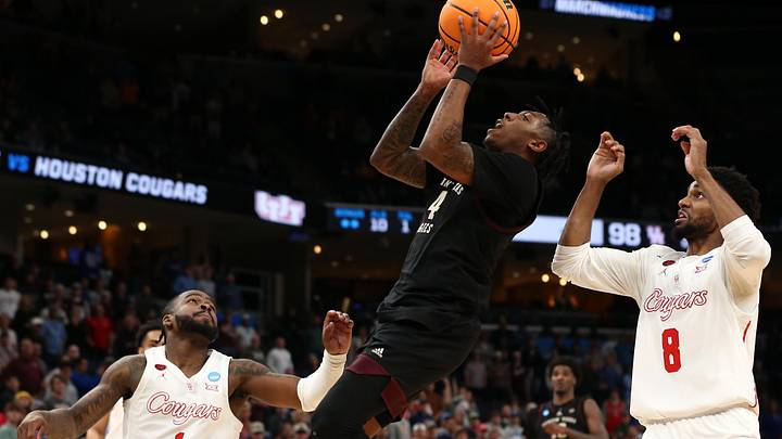 Mar 24, 2024; Memphis, TN, USA; Texas A&M Aggies guard Wade Taylor IV (4) shoots between Houston Cougars guard Jamal Shead (1) and guard Mylik Wilson (8) during over time in the second round of the 2024 NCAA Tournament at FedExForum. Mandatory Credit: Petre Thomas-USA TODAY Sports