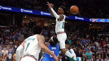 Apr 24, 2025; Memphis, Tennessee, USA; Memphis Grizzlies guard Ja Morant (12) looses control of the ball as he is fouled by Oklahoma City Thunder guard Luguentz Dort (5) during the second quarter during game three for the first round of the 2024 NBA Playoffs at FedExForum. Mandatory Credit: Petre Thomas-Imagn Images