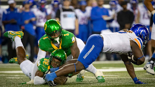 Boise State running back Ashton Jeanty is brought down by Oregon inside linebacker Devon Jackson and Oregon defensive end Jor