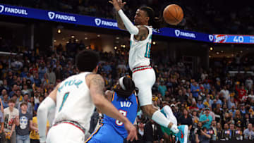 Apr 24, 2025; Memphis, Tennessee, USA; Memphis Grizzlies guard Ja Morant (12) looses control of the ball as he is fouled by Oklahoma City Thunder guard Luguentz Dort (5) during the second quarter during game three for the first round of the 2024 NBA Playoffs at FedExForum. Mandatory Credit: Petre Thomas-Imagn Images