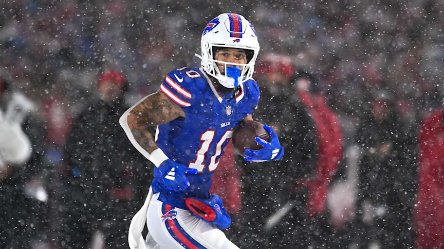 Khalil Shakir runs with the ball after making a catch in the snow.
