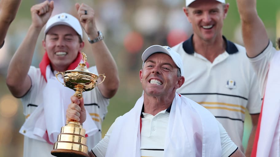 Team Europe's Rory McIlroy celebrates with the trophy after winning the Ryder Cup 