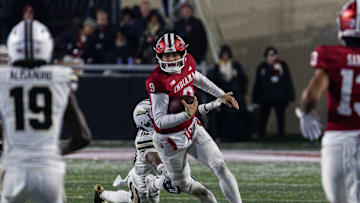 Nov 30, 2024; Bloomington, Indiana, USA; Indiana Hoosiers quarterback Kurtis Rourke (9) runs the ball while Purdue Boilermakers defensive back Kyndrich Breedlove (10)  defends in the second half at Memorial Stadium. Mandatory Credit: Trevor Ruszkowski-Imagn Images