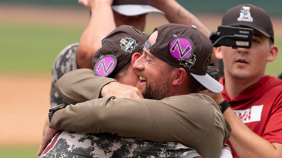 Alabama third baseman Jason Torres and Alabama head coach Rob Vaughn embrace.