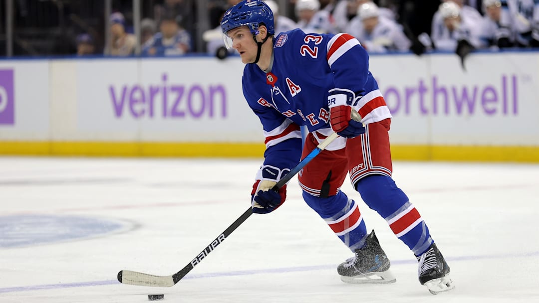 Jan 5, 2026; New York, New York, USA; New York Rangers defenseman Adam Fox (23) skates with the puck against the Utah Mammoth during the second period at Madison Square Garden. Mandatory Credit: Brad Penner-Imagn Images