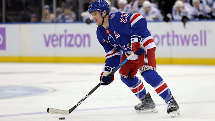 Jan 5, 2026; New York, New York, USA; New York Rangers defenseman Adam Fox (23) skates with the puck against the Utah Mammoth during the second period at Madison Square Garden. Mandatory Credit: Brad Penner-Imagn Images