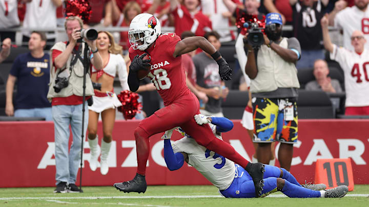 Los Angeles Rams defensive back Kamren Curl tries to tackle Arizona Cardinals wide receiver Marvin Harrison Jr.