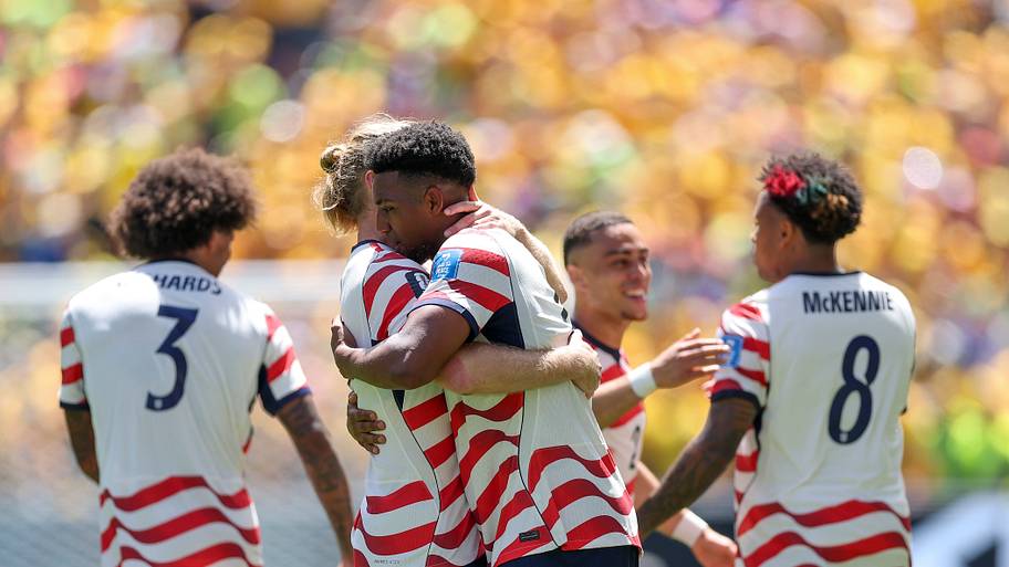 USMNT players hugging.