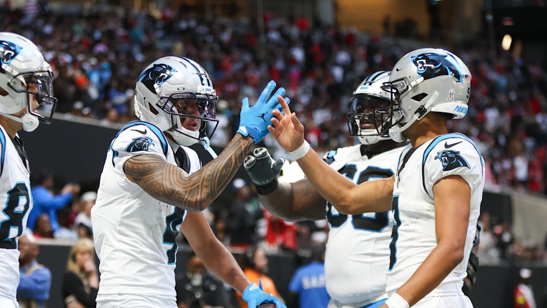 Nov 16, 2025; Atlanta, Georgia, USA; Carolina Panthers quarterback Bryce Young (9) shakes hands with wide receiver Tetairoa McMillan (4) after a touchdown in the fourth quarter against the Atlanta Falcons at Mercedes-Benz Stadium. Mandatory Credit: Brett Davis-Imagn Images