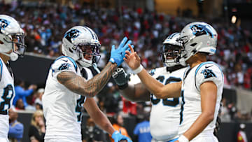 Nov 16, 2025; Atlanta, Georgia, USA; Carolina Panthers quarterback Bryce Young (9) shakes hands with wide receiver Tetairoa McMillan (4) after a touchdown in the fourth quarter against the Atlanta Falcons at Mercedes-Benz Stadium. Mandatory Credit: Brett Davis-Imagn Images