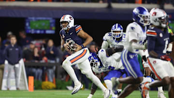 Nov 1, 2025; Auburn, Alabama, USA;  Auburn Tigers quarterback Ashton Daniels (12) scrambles for yardage against the Kentucky Wildcats during the third quarter at Jordan-Hare Stadium. Mandatory Credit: John Reed-Imagn Images