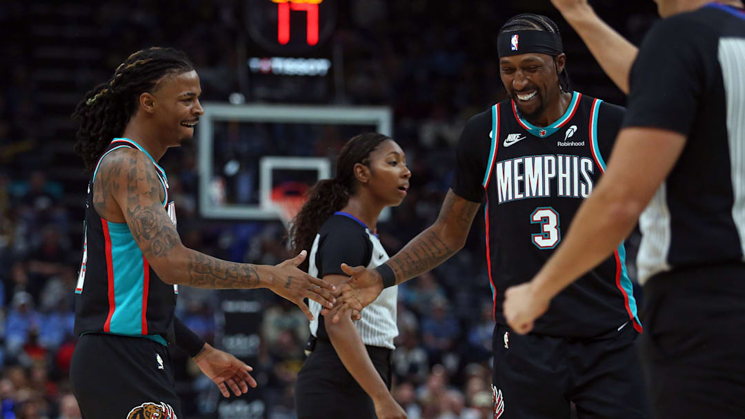 Oct 22, 2025; Memphis, Tennessee, USA; Memphis Grizzlies guard Ja Morant (12) reacts with forward Kentavious Caldwell-Pope (3) during the second quarter against the New Orleans Pelicans at FedExForum. Mandatory Credit: Petre Thomas-Imagn Images Oct 22, 2025; Memphis, Tennessee, USA; Memphis Grizzlies guard Ja Morant (12) reacts with forward Kentavious Caldwell-Pope (3) during the second quarter against the New Orleans Pelicans at FedExForum. Mandatory Credit: Petre Thomas-Imagn Images