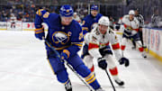 Oct 28, 2024; Buffalo, New York, USA;  Buffalo Sabres defenseman Rasmus Dahlin (26) and Florida Panthers center Jesper Boqvist (70) go after a loose puck during the third period at KeyBank Center. Mandatory Credit: Timothy T. Ludwig-Imagn Images