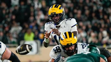 Oct 25, 2025; East Lansing, Michigan, USA; Michigan Wolverines quarterback Bryce Underwood (19) takes the snap against the Michigan State Spartans during the first half at Spartan Stadium. Mandatory Credit: Brendan Mullin-Imagn Images