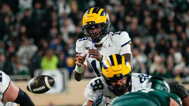 Oct 25, 2025; East Lansing, Michigan, USA; Michigan Wolverines quarterback Bryce Underwood (19) takes the snap against the Michigan State Spartans during the first half at Spartan Stadium. Mandatory Credit: Brendan Mullin-Imagn Images