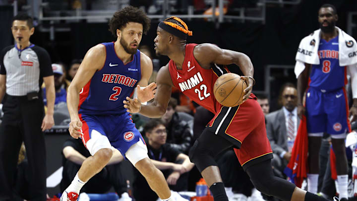 Dec 16, 2024; Detroit, Michigan, USA;  Miami Heat forward Jimmy Butler (22) controls the ball as Detroit Pistons guard Cade Cunningham (2) defends in the second half at Little Caesars Arena. Mandatory Credit: Rick Osentoski-Imagn Images