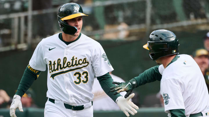 May 4, 2024; Oakland, California, USA; Oakland Athletics outfielder JJ Bleday (33) shakes hands with a bat boy after hitting a three-run home run against the Miami Marlins during the third inning at Oakland-Alameda County Coliseum. Mandatory Credit: Robert Edwards-USA TODAY Sports