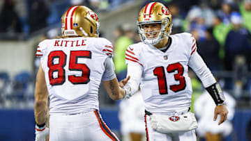 Dec 15, 2022; Seattle, Washington, USA; San Francisco 49ers quarterback Brock Purdy (13) celebrates with tight end George Kittle (85) during the late fourth quarter against the Seattle Seahawks at Lumen Field.