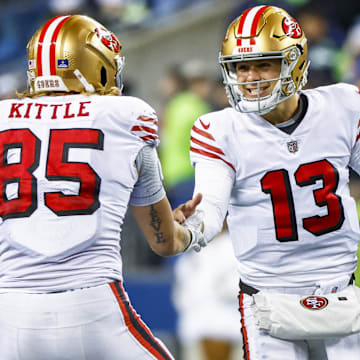 Dec 15, 2022; Seattle, Washington, USA; San Francisco 49ers quarterback Brock Purdy (13) celebrates with tight end George Kittle (85) during the late fourth quarter against the Seattle Seahawks at Lumen Field.