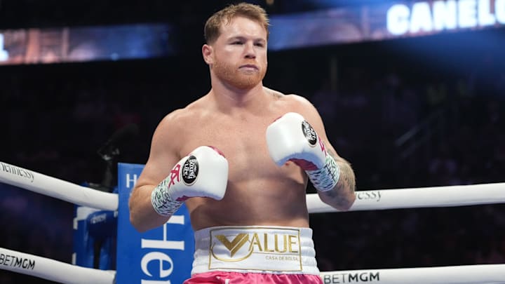 Canelo Alvarez (pink trunks) and Dimitry Bivol (black trunks) box during their light heavyweight championship bout at T-Mobile Arena. Canelo Alvarez (pink trunks) and Dimitry Bivol (black trunks) box during their light heavyweight championship bout at T-Mobile Arena.