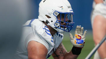 Kansas redshirt sophomore defensive lineman Gage Keys (17) lines up a play during Tuesday's practice inside the Kansas Indoor Practice Facility.