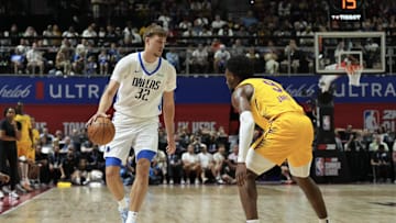Jul 10, 2025; Las Vegas, NV, USA; Dallas Mavericks forward Cooper Flagg (32) dribbles against Los Angeles Lakers guard Bronny James (9) in the first quarter of their game at Thomas & Mack Center. Mandatory Credit: Candice Ward-Imagn Images