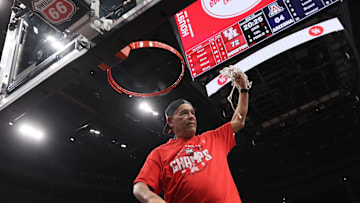Houston Cougars head coach Kelvin Sampson cuts the net after defeating the Arizona Wildcats in the Big 12 Conference Tournament Championship game