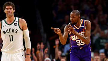 Mar 24, 2025; Phoenix, Arizona, USA; Phoenix Suns forward Kevin Durant (35) celebrates after Milwaukee Bucks center Brook Lopez (11) reacts to a play during the fourth quarter at Footprint Center. Mandatory Credit: Mark J. Rebilas-Imagn Images