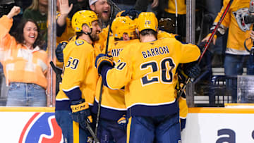 Jan 18, 2025; Nashville, Tennessee, USA;  Nashville Predators left wing Filip Forsberg (9) celebrates his goal with his teammates  against the Minnesota Wild during the third period at Bridgestone Arena. Mandatory Credit: Steve Roberts-Imagn Images