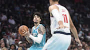 Nov 22, 2025; Charlotte, North Carolina, USA; Charlotte Hornets guard LaMelo Ball (1) looks to pass as he is defended by Los Angeles Clippers center Brook Lopez (11) during the first half at the Spectrum Center. Mandatory Credit: Sam Sharpe-Imagn Images