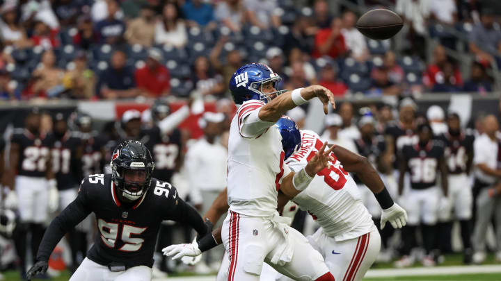 Aug 17, 2024; Houston, Texas, USA;  New York Giants quarterback Daniel Jones (8) passes against Houston Texans defensive end Derek Barnett (95) rush in the first quarter at NRG Stadium. Mandatory Credit: Thomas Shea-USA TODAY Sports