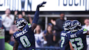 Nov 9, 2025; Seattle, Washington, USA; Seattle Seahawks defensive end DeMarcus Lawrence (0) celebrates after recovering a fumble to score a touchdown during the second quarter against the Arizona Cardinals at Lumen Field.