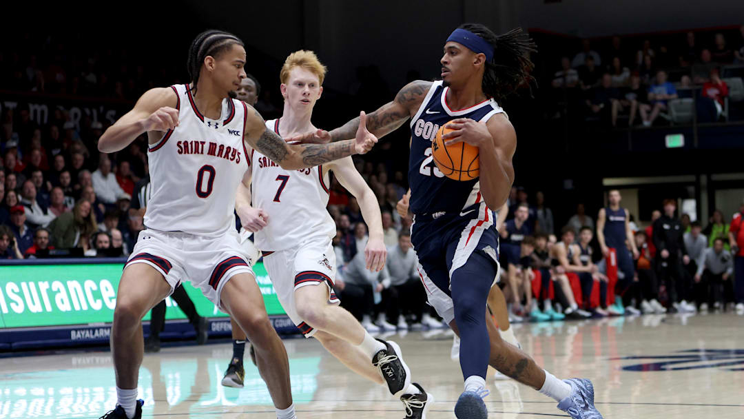 Gonzaga Bulldogs guard Adam Miller (23) drives towards the basket while being defended by Saint Mary's Gaels guard Mikey Lewis (0) during the first half at University Credit Union Pavilion.