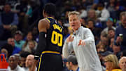 Mar 28, 2022; Memphis, Tennessee, USA; Golden State Warriors head coach Steve Kerr (right) talks with forward Jonathan Kuminga (00) during the first half against the Memphis Grizzlies at FedExForum. Mandatory Credit: Petre Thomas-Imagn Images