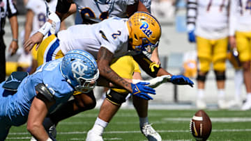 Oct 5, 2024; Chapel Hill, North Carolina, USA; Pittsburgh Panthers wide receiver Kenny Johnson (2) and North Carolina Tar Heels defensive lineman Beau Atkinson (12) fight for a fumble in the first quarter at Kenan Memorial Stadium. Mandatory Credit: Bob Donnan-Imagn Images