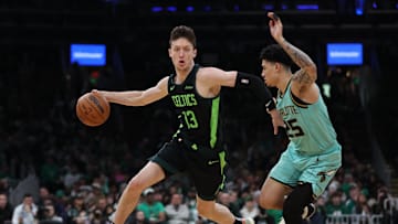 Apr 13, 2025; Boston, Massachusetts, USA; Boston Celtics forward Drew Peterson (13) dribbles down the court during the first half against the Charlotte Hornets at TD Garden. Mandatory Credit: Paul Rutherford-Imagn Images