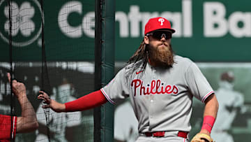 Apr 13, 2025; St. Louis, Missouri, USA; Philadelphia Phillies outfielder Brandon Marsh (16) braces himself against the screen after chasing a ball into the left field corner against the St. Louis Cardinals at Busch Stadium. 