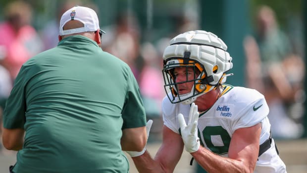 Green Bay Packers tight end Luke Musgrave goes through a blocking drill with position coach John Dunn.