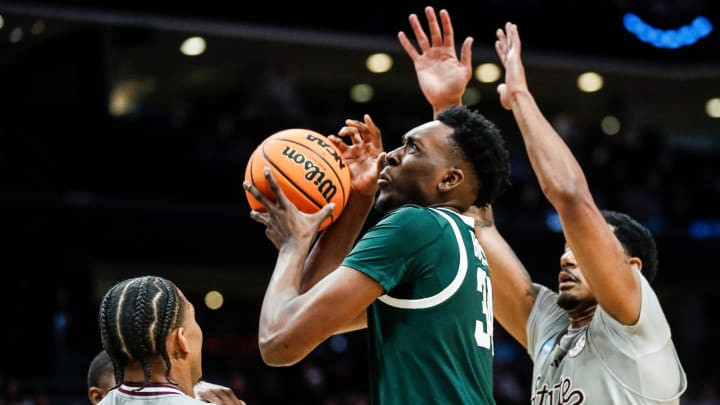 Michigan State forward Xavier Booker (34) is defended by Mississippi State guard Shakeel Moore (3) and forward Tolu Smith (1) during the second half of NCAA tournament West Region first round at Spectrum Center in Charlotte, N.C. on Thursday, March 21, 2024.