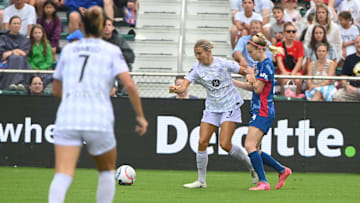 July 7, 2024; Cary, North Carolina, USA; Racing Louisville FC midfielder Kayla Fischer (9) battles North Carolina Courage forward Tyler Lussi (14) during the first half at WakeMed Soccer Park. Mandatory Credit: Rob Kinnan-USA TODAY Sports