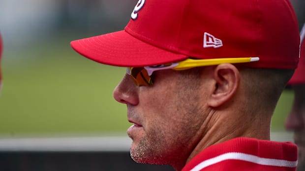 St. Louis Cardinals bench coach Skip Schumaker in a red hat and red jersey
