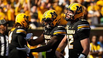 Oct 19, 2024; Columbia, Missouri, USA; Missouri Tigers quarterback Brady Cook (12) celebrates with teammates after converting a two-point conversion during the second half against the Auburn Tigers at Faurot Field at Memorial Stadium. Mandatory Credit: Jay Biggerstaff-Imagn Images