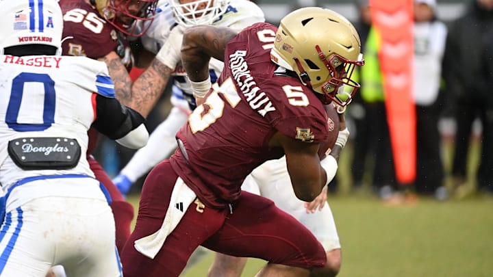 Dec 28, 2023; Boston, MA, USA; Boston College Eagles running back Kye Robichaux (5) breaks through tackles and runs the ball during the second half against the Southern Methodist Mustangs at Fenway Park. Mandatory Credit: Eric Canha-Imagn Images