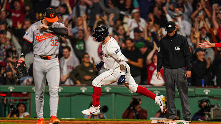 Sep 11, 2024; Boston, Massachusetts, USA; Boston Red Sox left fielder Tyler O'Neill (17) his a three run home run to win the game against the Baltimore Orioles in ten innings at Fenway Park. Mandatory Credit: David Butler II-Imagn Images