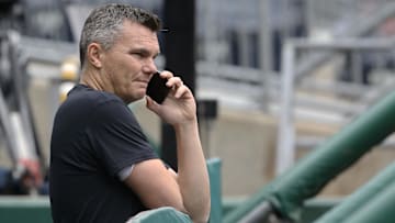 May 24, 2022; Pittsburgh, Pennsylvania, USA;  Pittsburgh Pirates general manager Ben Cherington talks on the phone in the dugout before the game against the Colorado Rockies at PNC Park. Mandatory Credit: Charles LeClaire-Imagn Images