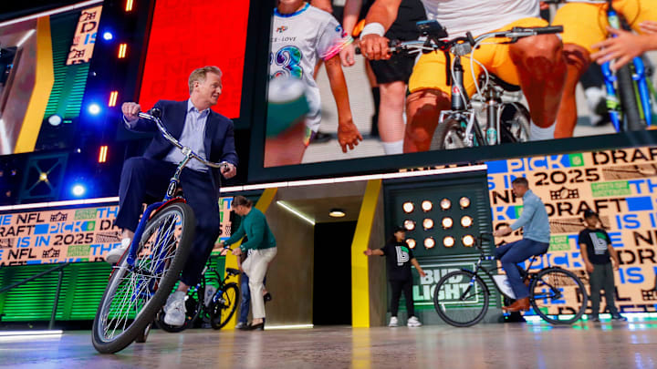 NFL Commissioner Roger Goodell rides a bicycle onto the Draft Theater stage before the first round of the 2025 NFL Draft