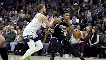 Nov 24, 2025; Sacramento, California, USA; Sacramento Kings forward Keegan Murray (13) dribbles the ball while being defended by Minnesota Timberwolves guard Donte DiVincenzo (0) during the second quarter at Golden 1 Center. Mandatory Credit: Dennis Lee-Imagn Images