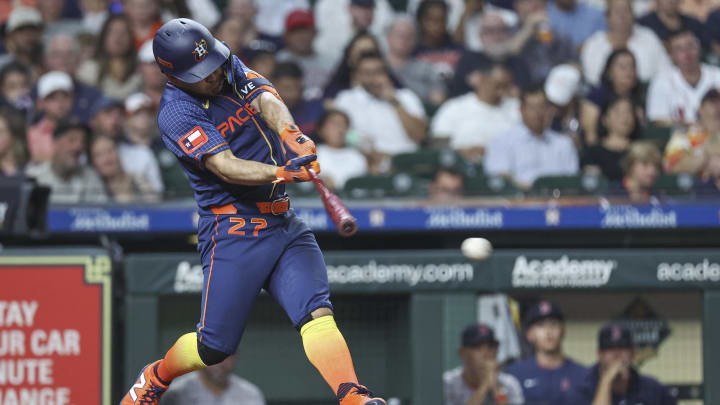 Aug 19, 2024; Houston, Texas, USA; Houston Astros second baseman Jose Altuve (27) hits a single during the fifth inning against the Boston Red Sox at Minute Maid Park.