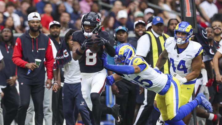 Aug 24, 2024; Houston, Texas, USA; Houston Texans wide receiver John Metchie III (8) runs with the ball as Los Angeles Rams safety Jason Taylor II (25) attempts to make a tackle during the first quarter at NRG Stadium. Mandatory Credit: Troy Taormina-USA TODAY Sports